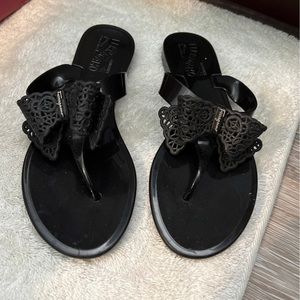 Black jelly Ferragamo shoes with bow tie